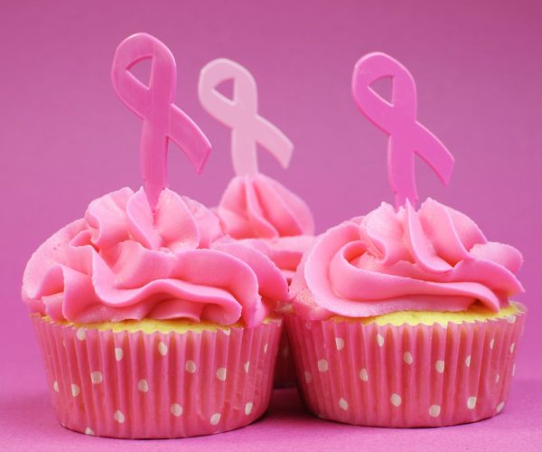 Pink cupcakes with Pink Ribbon symbol for International Breast Cancer Awareness charity month of October. Close up.
